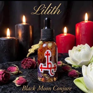May include: A clear glass dropper bottle filled with botanical oil and dried petals, featuring a gold-toned snake charm on the neck and a red sigil sticker on the front. The text Lilith and Black Moon Conjure is printed in gold script.