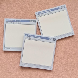 May include: Three square sticky notes designed to resemble a classic computer notepad application window. Each note features a light grey border, a cream-coloured writing area, and the text "untitled - Notepad" with menu options File, Edit, Search, Help.