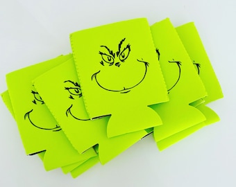 May include: A set of six green can coolers featuring a black and white illustration of the Grinch's face.