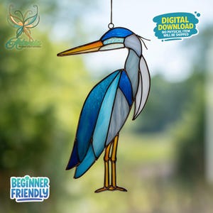 May include: Stained glass heron suncatcher in shades of blue, white, and gray, with a yellow and orange beak and legs. The artwork is suspended by a chain. Text on the image reads "DIGITAL DOWNLOAD NO PHYSICAL ITEM WILL BE SHIPPED" and "BEGINNER FRIENDLY".