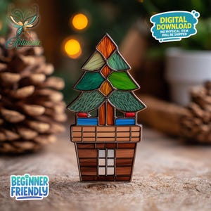 May include: A decorative Christmas tree pin with a stained glass design. The tree features green, orange, and blue hues, set in a brown pot with a window. The pin includes the text "Beginner Friendly" and "Digital Download".