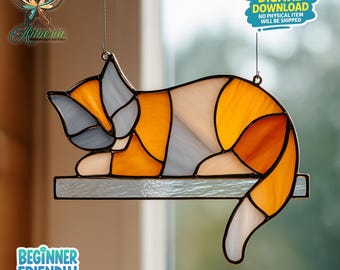 May include: Stained glass cat suncatcher in orange, white, and gray. The cat is lying down on a shelf. The image includes the text "DIGITAL DOWNLOAD NO PHYSICAL ITEM WILL BE SHIPPED" and "BEGINNER FRIENDLY".