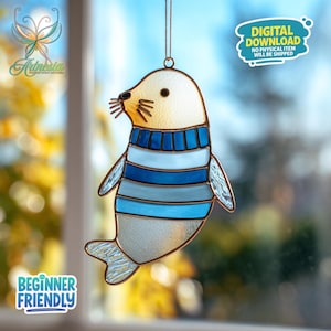 May include: Stained glass seal suncatcher with a cream-colored head, a blue and white striped body, and copper-colored edging. The suncatcher has the text "Beginner Friendly" and "Digital Download No Physical Item Will Be Shipped".