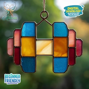 May include: A stained glass suncatcher in a geometric design, featuring a mix of colors including blue, yellow, red, and orange. The suncatcher is suspended by a thin cord. Text on the image reads "DIGITAL DOWNLOAD NO PHYSICAL ITEM WILL BE SHIPPED" and "BEGINNER FRIENDLY".