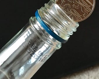 Coin in the Bottle Magic - Folding Coin 10p - with 5 extra bands.