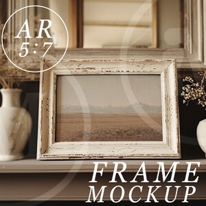 May include: White distressed wood picture frame with a landscape photo inside. The frame is sitting on a brown shelf with two white vases and dried flowers on either side. The text "FRAME MOCKUP" is below the frame.