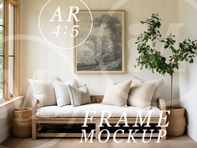 May include: A white couch with beige pillows sits in a room with white walls and wood floors. A framed black and white print hangs on the wall above the couch. A potted plant with green leaves stands to the right of the couch. The text "FRAME MOCKUP" is printed on the floor in front of the couch.