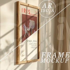 May include: A framed print of a vintage botanical illustration of an iris flower. The print is in a light wood frame and is hanging on a white wall. The text on the print reads "IRIS No. 1 KAEEMPERI".