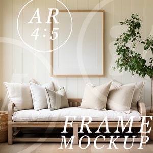 May include: A white couch with beige pillows sits in a room with white walls and wood paneling. A large, empty picture frame hangs above the couch. A potted plant with green leaves stands to the right of the couch. The text "FRAME MOCKUP" is printed in white on the floor in front of the couch.