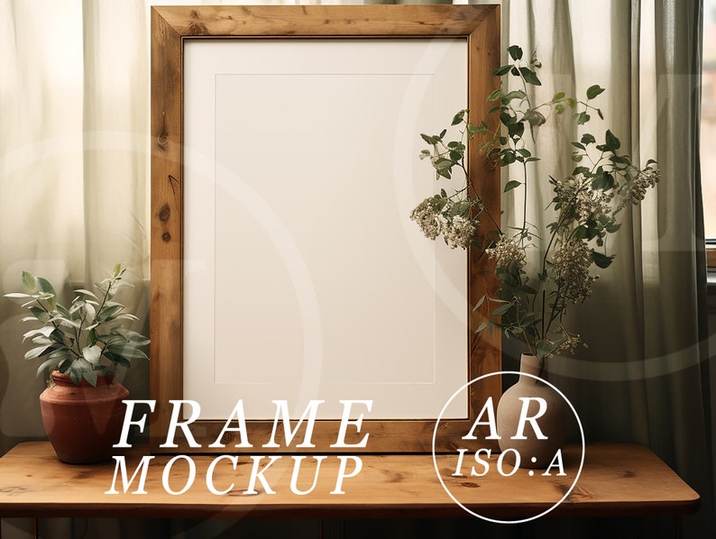 May include: A wooden picture frame mockup with a white mat, set on a wooden table. The frame is surrounded by a small potted plant and a vase of flowers. The text "FRAME MOCKUP" and "AR ISO:A" are visible.