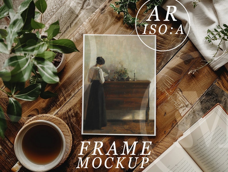 May include: A framed painting of a woman in a long dress standing in a room with a wooden chest. The painting is on a wooden table with a cup of coffee and a book. The text "FRAME MOCKUP" is below the painting.