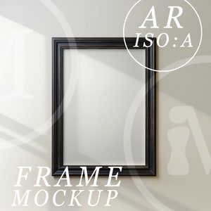 May include: A black picture frame mockup on a white wall. The frame is empty and ready for your design.