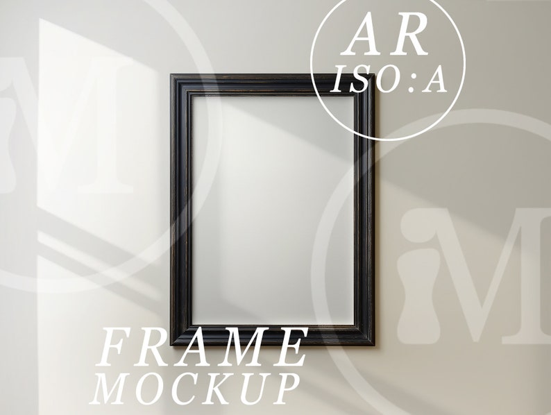 May include: A black picture frame mockup on a white wall. The frame is empty and ready for your design.