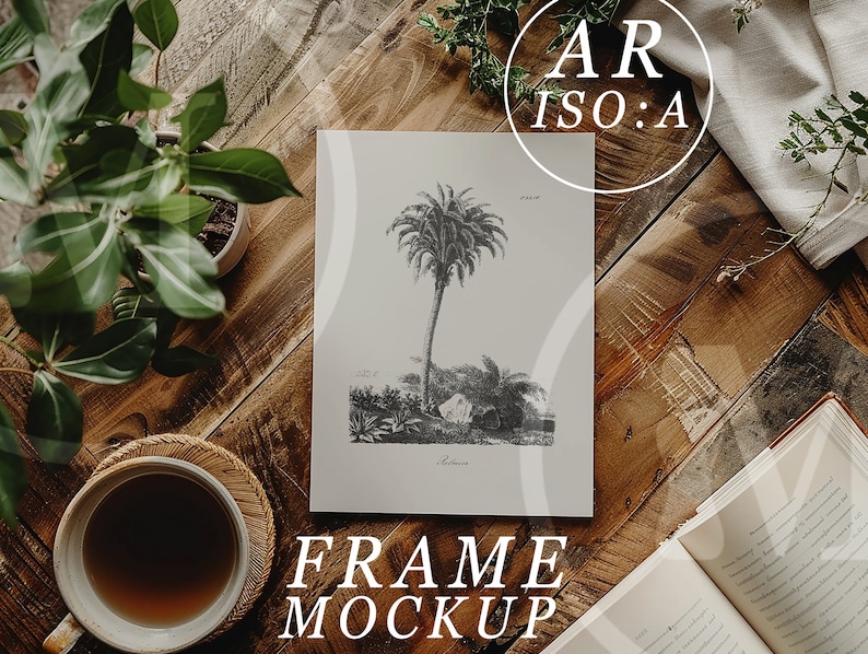 May include: A black and white illustration of a palm tree on a white background, framed and sitting on a wooden table with a cup of coffee and plants. The text "FRAME MOCKUP" is below the frame.