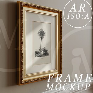 May include: A gold-colored ornate picture frame with a black and white print of a palm tree inside. The frame is hanging on a light beige wall.