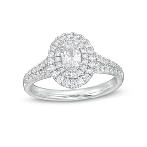 May include: A silver engagement ring with a large oval-shaped center diamond surrounded by two rows of smaller diamonds.