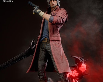 May include: A detailed figurine of a character in a red coat, holding a gun and a large black sword. The figure stands on a rocky base with glowing red orbs. The figure has white hair and is wearing a blue shirt and black pants. The KC Studio logo is in the top left.