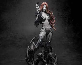 May include: A dark gray and silver female figurine with long red hair, standing on a base with three smaller gray and silver figures. The figurine is wearing a detailed, intricate costume with a flowing cape.