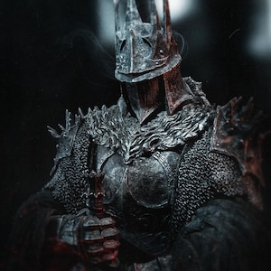 May include: A detailed, dark image of a knight in full armor. The knight wears a spiked helmet and chest armor, holding a sword. The armor is a dark, metallic color, with chainmail visible on the shoulders. The overall aesthetic is gothic and imposing.