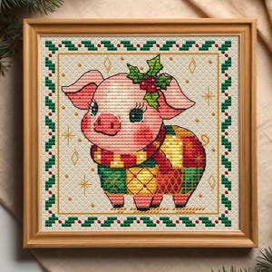 May include: A framed cross-stitch featuring a pig wearing a scarf and holly. The pig is pink with a green, yellow, and red scarf. The frame is wood with a green and red border. The background is beige.