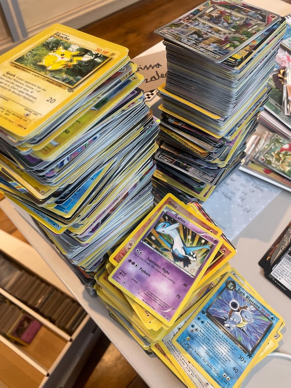 stacks of pokemon cards Amazon.com: 50+ Official Pokemon Cards Collection with 5 Foils in Any  Combination and at Least 1 Rarity, GX, EX, FA, Tag Team, Or Secret Rare :  Toys & Games main image 0