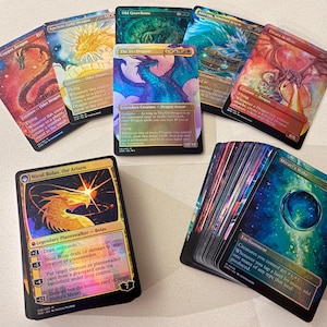 May include: A collection of Magic: The Gathering trading cards featuring vibrant, full-art illustrations of dragons and magical artifacts. The cards display various colors including red, blue, gold, and green, with metallic foil finishes and printed text.