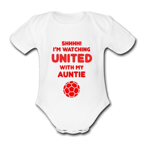 May include: White baby grow with red text that reads "Shhhh! I'm watching United with my Auntie" and a red football graphic.