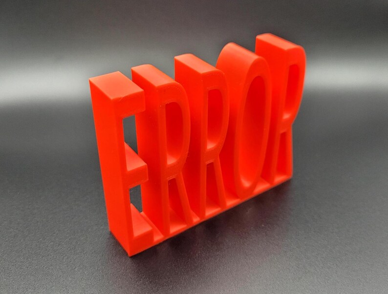 May include: A red 3D printed word "ERROR" with each letter standing on its own. The letters are all the same size and are made of a smooth, glossy plastic.