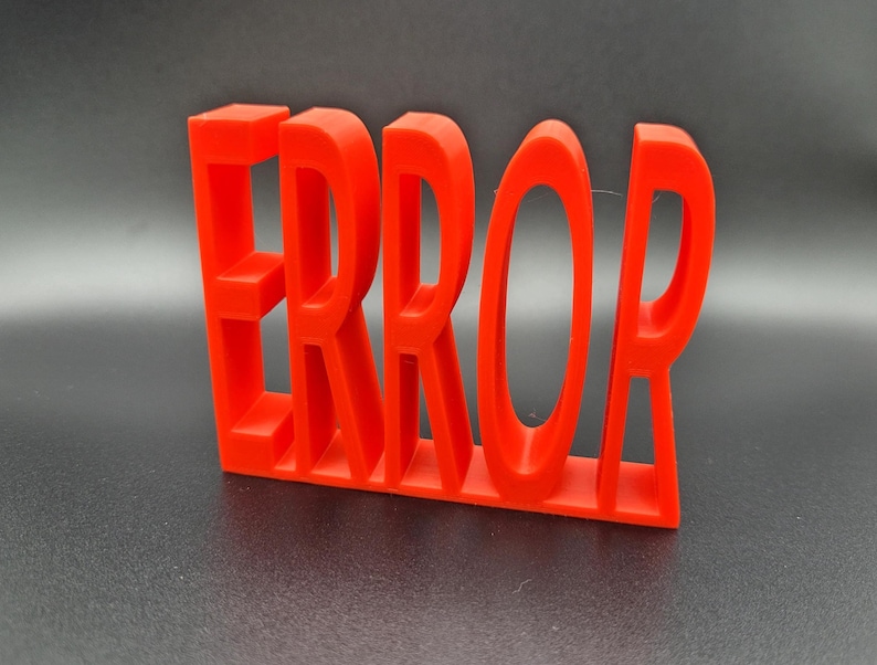 May include: Red plastic letters spelling out the word "ERROR" in a 3D style.