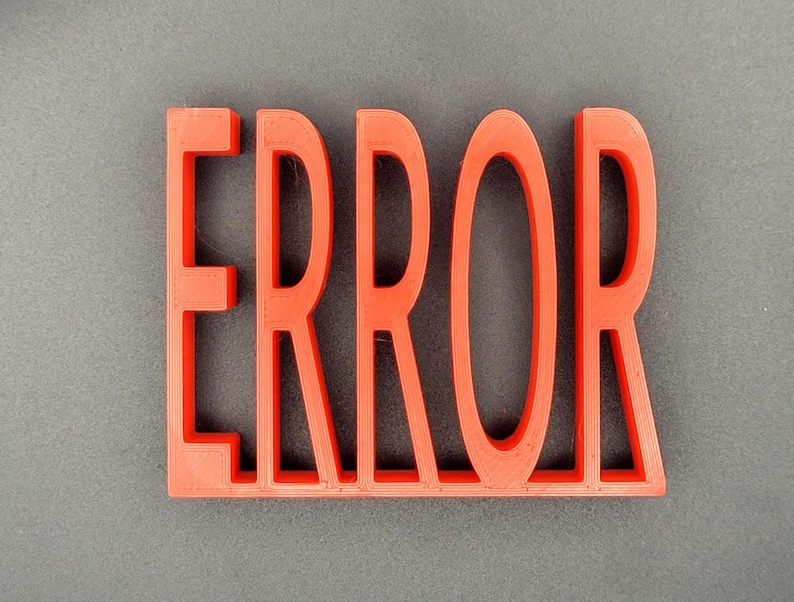 May include: A red plastic sign with the word "ERROR" in large, bold letters.