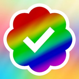 May include: A rainbow-colored checkmark inside a white flower-shaped outline. The checkmark is white and the background is a blurred rainbow.