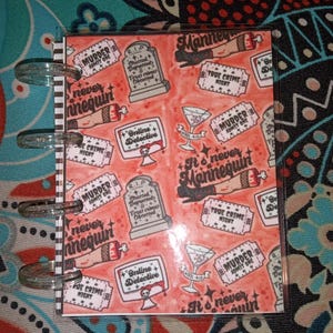 May include: A set of three ceramic mugs with a speckled, cream-colored glaze. Each mug features a different hand-painted design: a green leaf, a blue flower, and a yellow sun. The mugs have a simple, modern design.