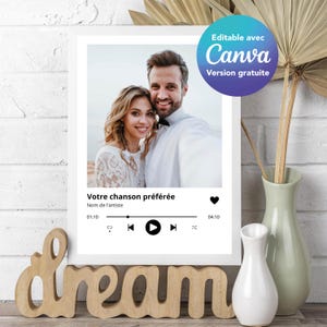 May include: A white framed print with a photo of a couple, a music player graphic, and the text "Votre chanson préférée" and "Nom de l'artiste". The print has a black heart icon, play, rewind, and fast forward buttons, and the text "01:10" and "04:10".