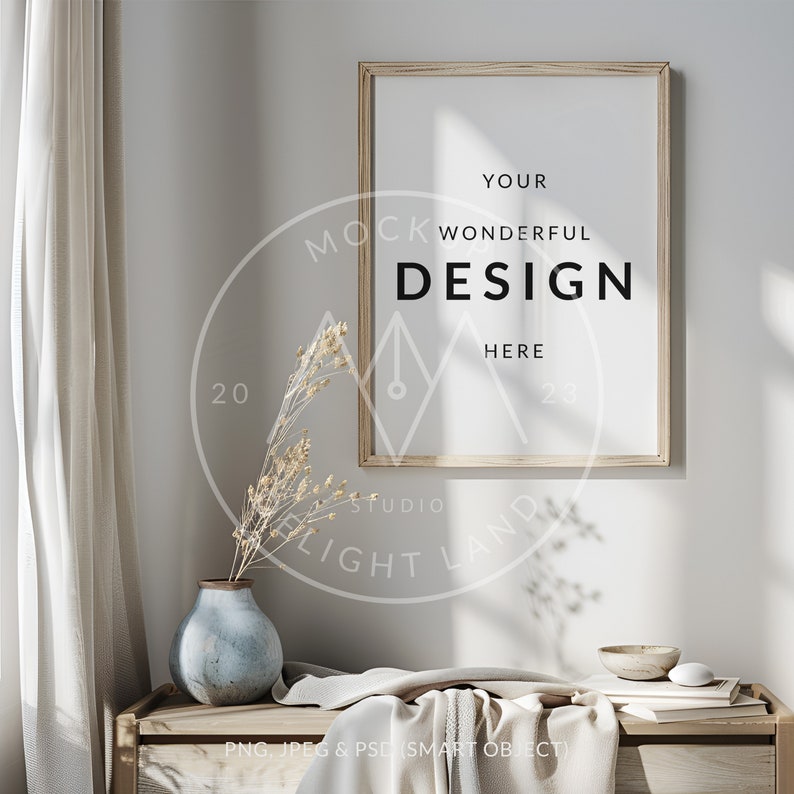 May include: A wooden frame with a white mat and a white background. The text "YOUR WONDERFUL DESIGN HERE" is printed in black on the white background. The frame is hanging on a white wall with a vase of dried flowers and a wooden table in the foreground.