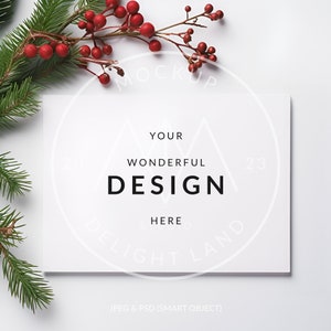 May include: A white card with the text "YOUR WONDERFUL DESIGN HERE" in black lettering, surrounded by a green pine branch with red berries.