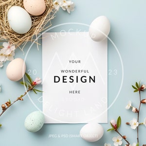 May include: A white card with the text "YOUR WONDERFUL DESIGN HERE STUDIO DELIGHT LAND JPEG & PSD (SMART OBJECT)" on a light blue background with white eggs, a nest, and white flowers.