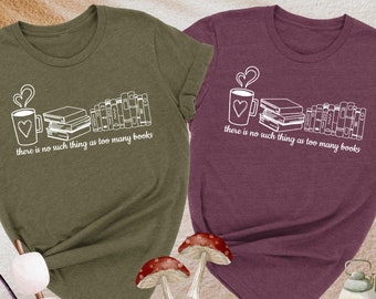 May include: Two t-shirts with a book and coffee cup design. The text on the shirts reads "there is no such thing as too many books". The shirts are available in heather olive and heather maroon.