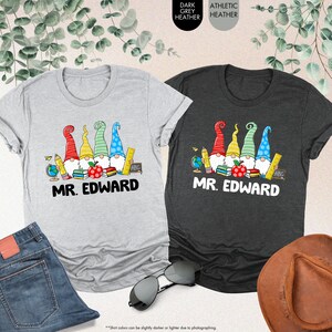 a couple of t - shirts sitting on top of a table