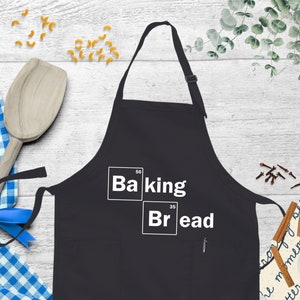 a black apron with the words baking and bread on it