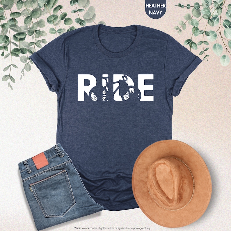 a t - shirt that says ride next to a hat and jeans