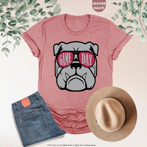 a pink shirt with a dog wearing sunglasses