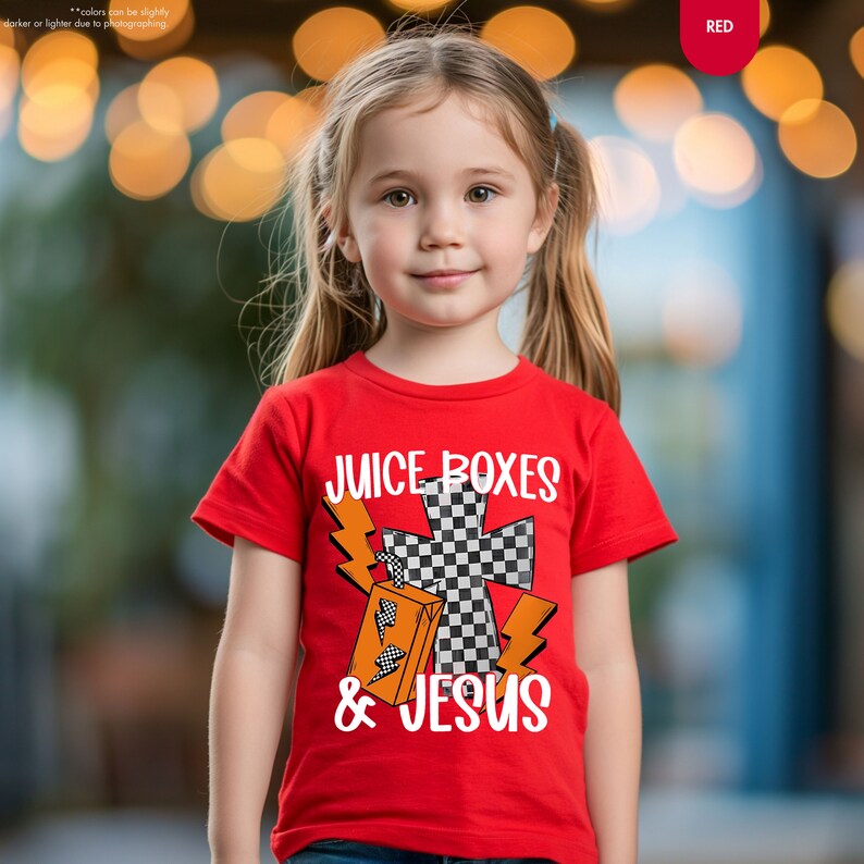 a little girl wearing a red shirt with a checkered cross on it