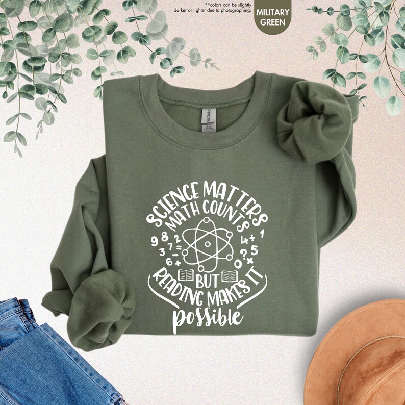 a green shirt that says science matters and a hat next to it