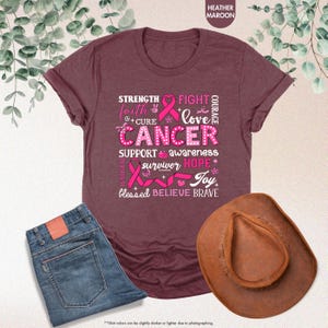 a t - shirt with a pink ribbon and a cowboy hat