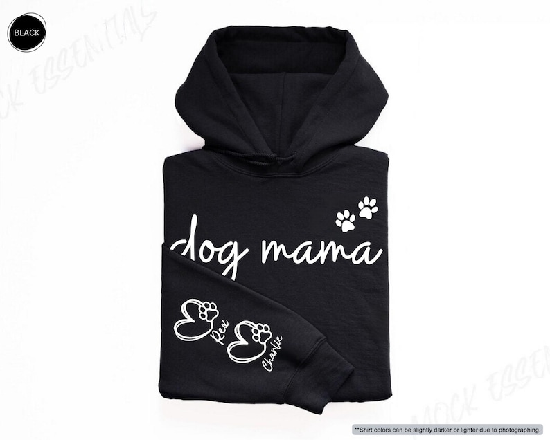 May include: Black hoodie with the words "dog mama" in white script, along with paw prints and the names "Rex" and "Charlie." The hoodie has a drawstring hood and a kangaroo pocket.