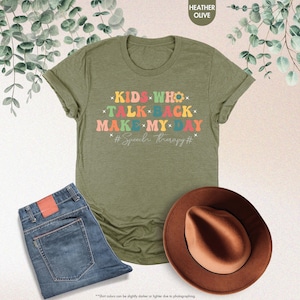 May include: A green t-shirt with the text "KIDS WHO TALK BACK MAKE MY DAY #Speech therapy#" in rainbow colors.