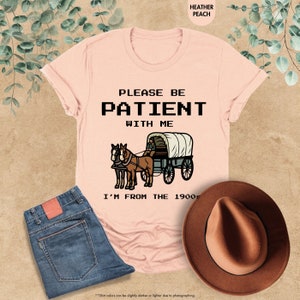 a t - shirt that says please be patient with me i'm from the