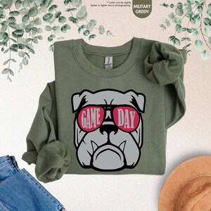 a green shirt with a bulldog wearing sunglasses