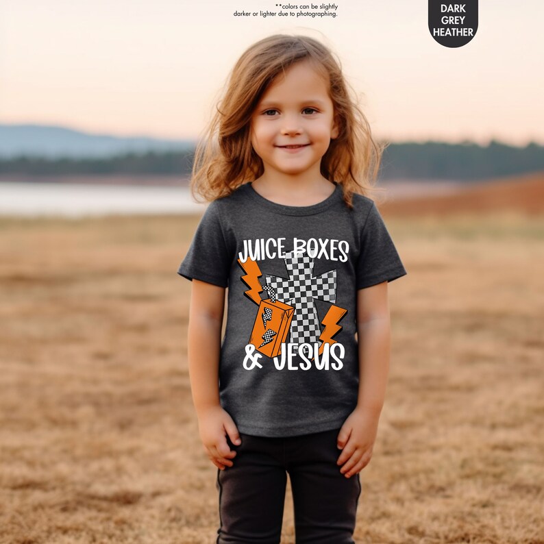 a little girl that is standing in the grass