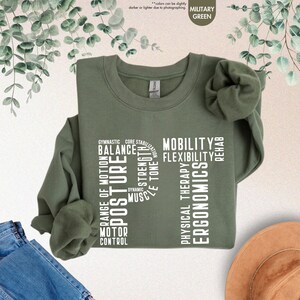 a green t - shirt with words on it and a hat next to it